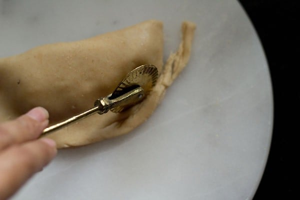 shaping gujiya with a pastry cutter