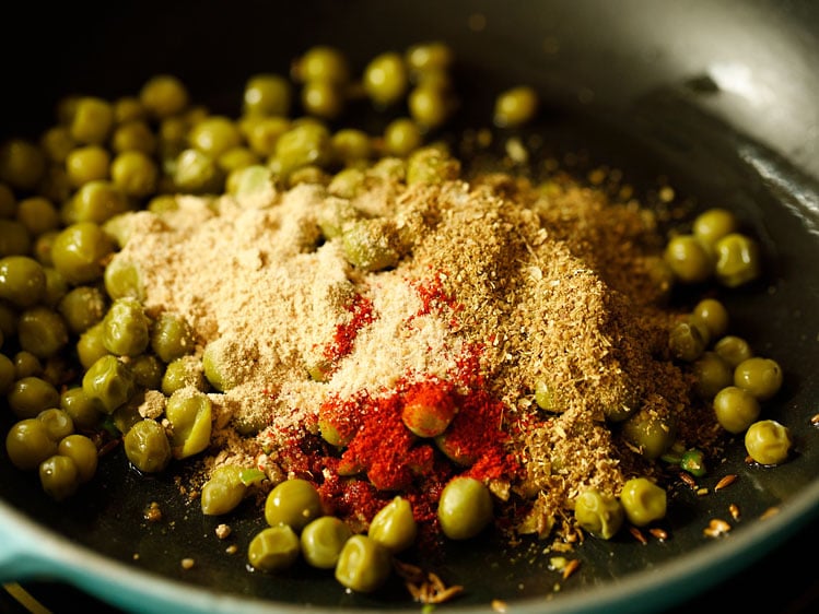 green peas, spice powders added in the pan