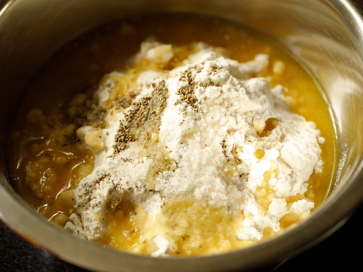 flour, carom seeds, salt, ghee in a bowl 