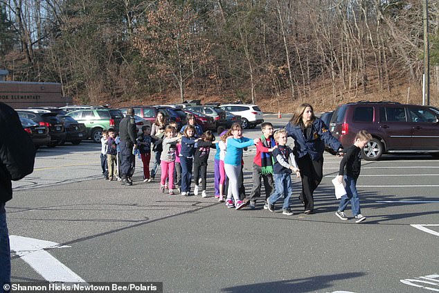 SANDY HOOK: On December 14, 2012, 26 people were shot dead at Sandy Hook Elementary School in Newtown, Connecticut. In the tragically infamous image, two Connecticut State Police officers accompany a class of students as they are shepherded away from the deadly shooting