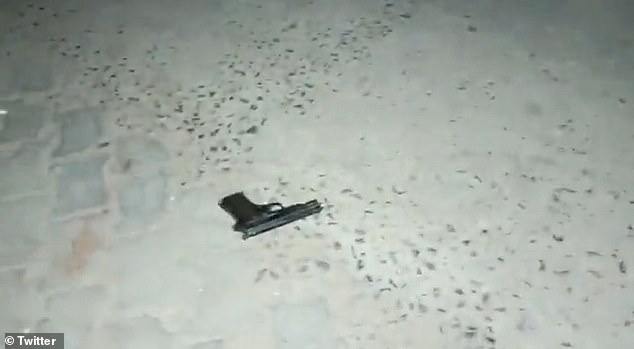 A gun is seen on the ground after a police constable and a journalist were also reported to have been injuries in the melee of bullets