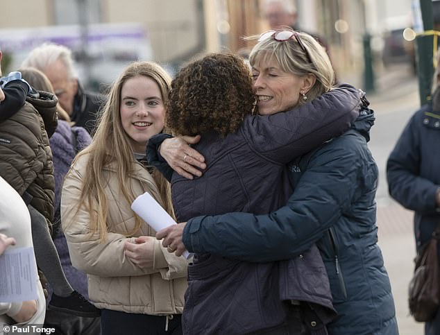 Wednesday marked the first time Amelie,  (left) who is applying to go to university, was pictured since she was a toddler. It gives a glimpse of what her older sibling may now look like as an adult. The 18-year-old is pictured with her mother, Kate (right), who is hugging a vigil attendee