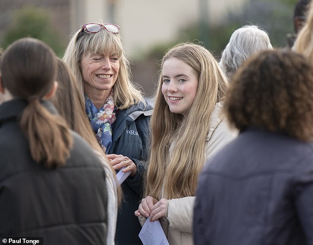 Amelie, with her long blonde hair and casually dressed in navy leggings, trainers and cream puffa jacket, was warmly welcomed by locals and supporters during an informal prayer gathering in their home village of Rothley, Leicestershire. Amelie is pictured with her mother