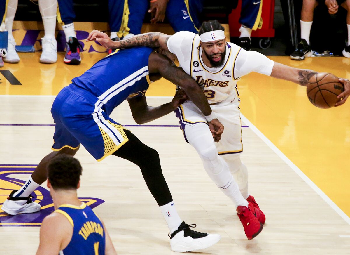 The Lakers' Anthony Davis drives on the Warriors' JaMychal Green during Game 3. 