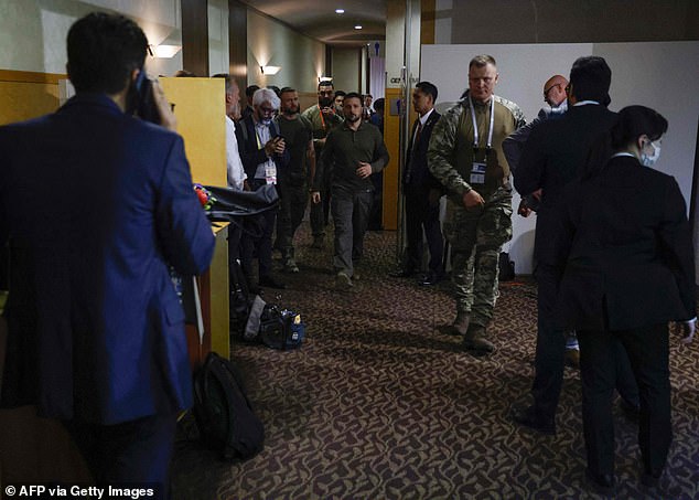 Ukraine's President Volodymyr Zelensky walks through the corridor of the Grand Prince Hotel where the G7 summit is taking place