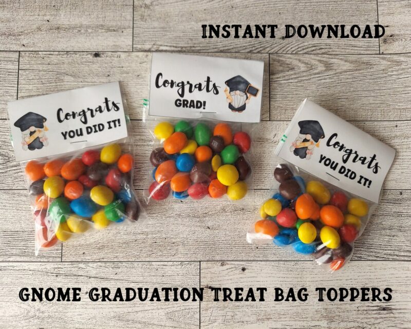 Three treat bags say Congrats Grad and are filled with bright colored candies.