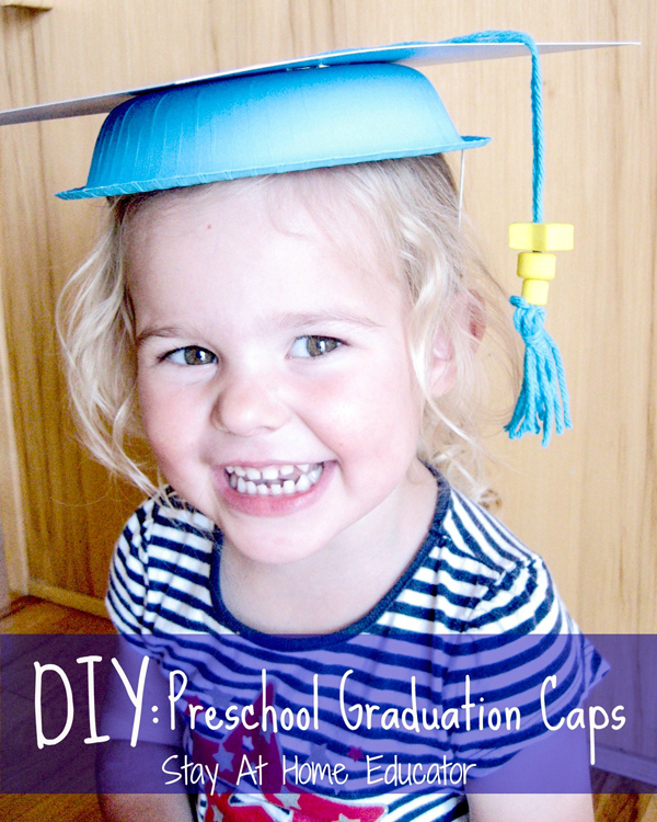A small child is seen wearing a homemade graduation cap made from yarn, beads, and a paper bowl.