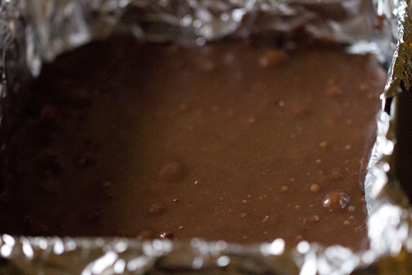 chocolate fudge mixture poured in the square tin lined with aluminium foil. 