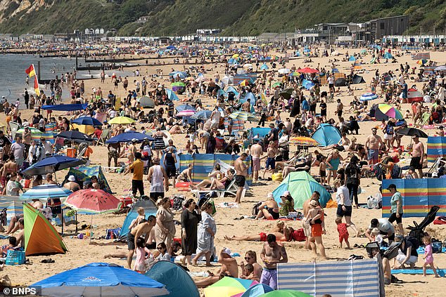 BOURNEMOUTH: Beachgoers head to the coast to enjoy the bright sunshine and warm temperatures in Bournemouth, Dorset, on the bank holiday weekend
