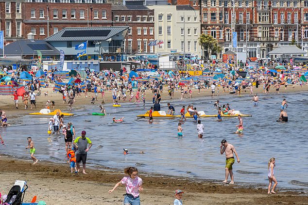 WEYMOUTH: Holidaymakers in the seaside town of Weymouth, Dorset, enjoying the sea. People have been told to watch out for each other in the water this Bank Holiday