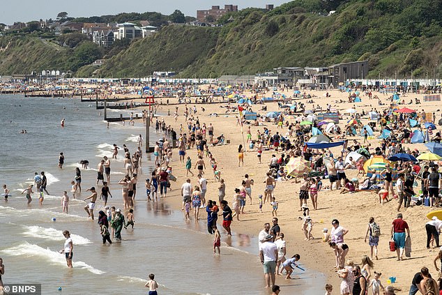 Hundreds flocked to the beach in Bournemouth, Dorset today with their umbrellas and picnic blankets