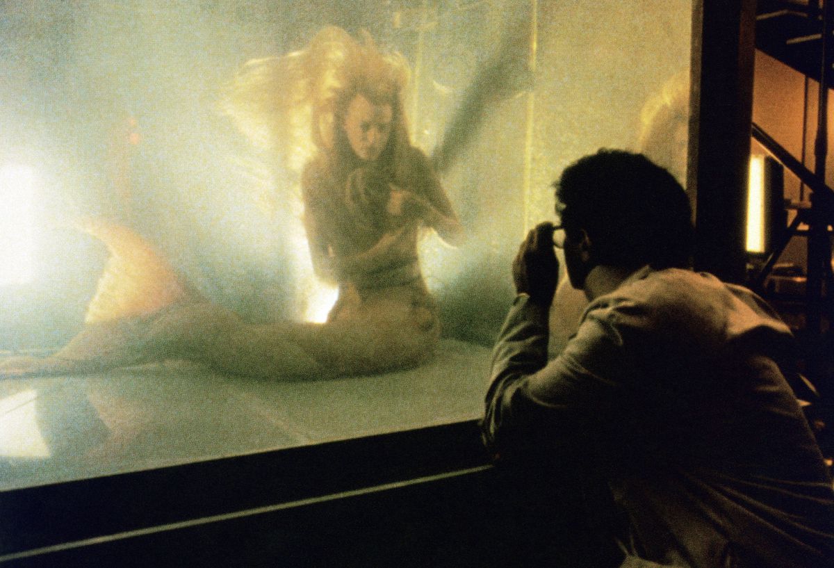 A bespectacled Tom Hanks peers at the mermaid Daryl Hannah inside an aquarium in Splash.
