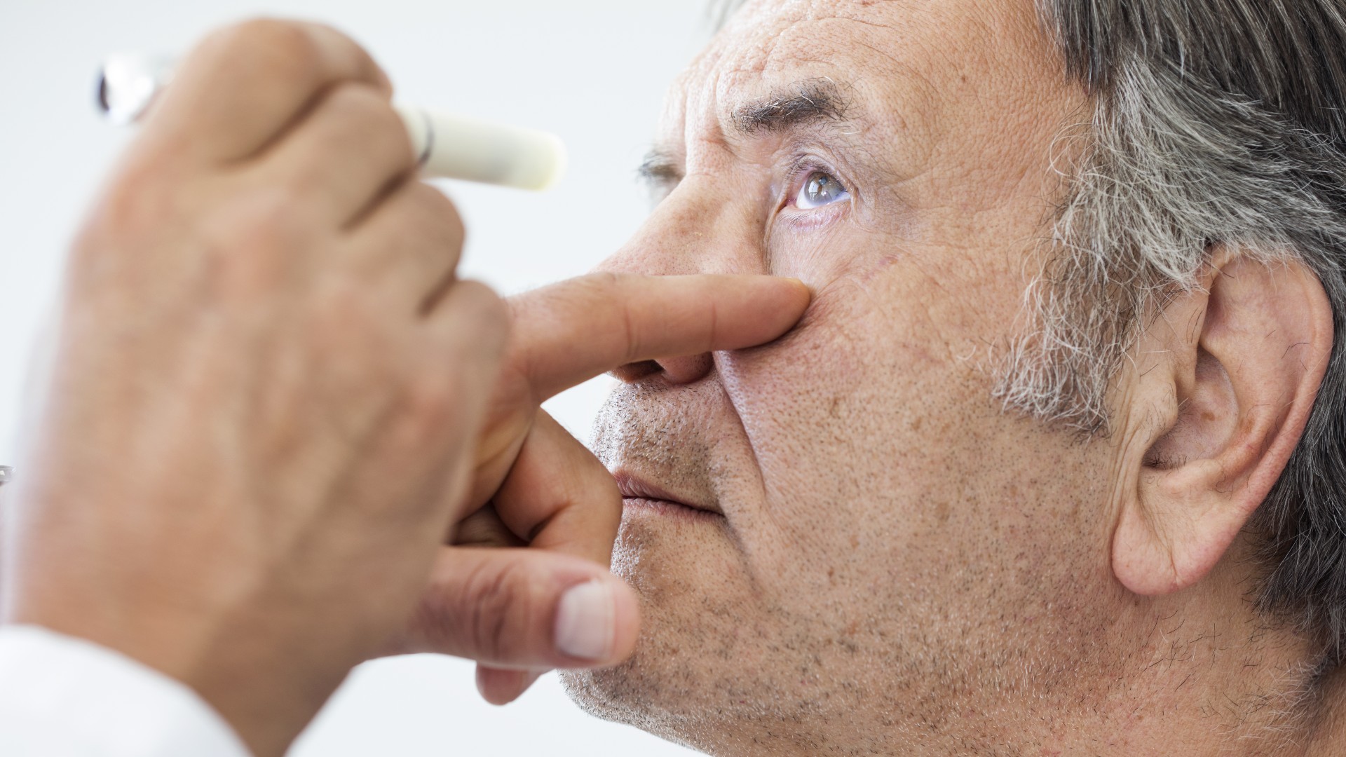Elderly man examined by an ophthalmologist. sebra via Shutterstock