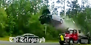 Moment car flies through the air after driving up tow truck ramp