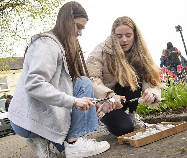 Madeleine McCann's sister Amelie, 18, (right) lit a candle in her memory as she joined her parents and well wishers on the poignant 16th anniversary of her disappearance