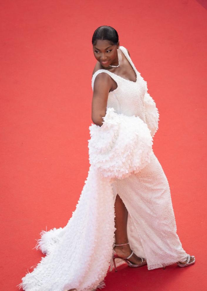 Fatoumata Guinea Kaba in a voluminous white dress poses on a red carpet in Cannes, France - Friday 26 May 2023