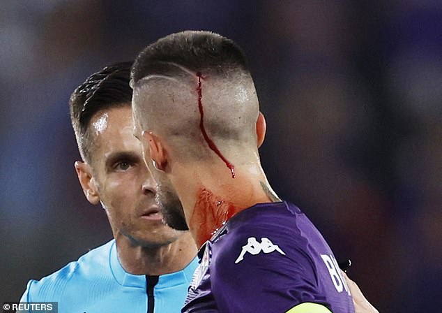 Fiorentina captain Cristiano Biraghi was treated for blood dripping down his neck after he was apparently hit by a vape pen while taking a corner in front of the Irons supporters