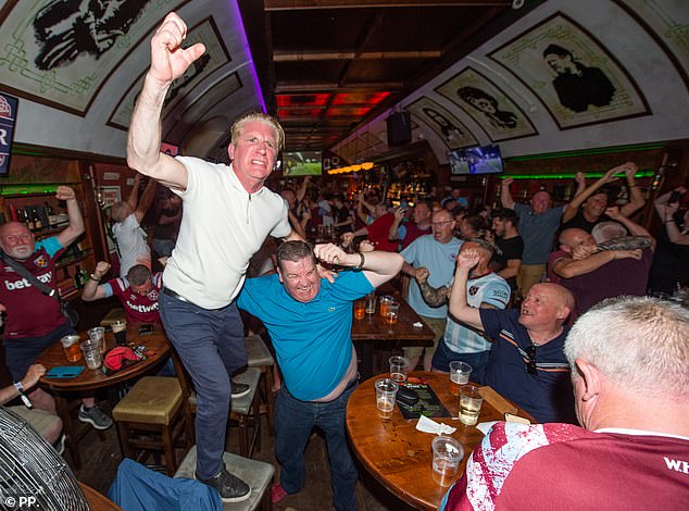 West Ham fans react after the opening goal in the Dubliner Pub in Prague