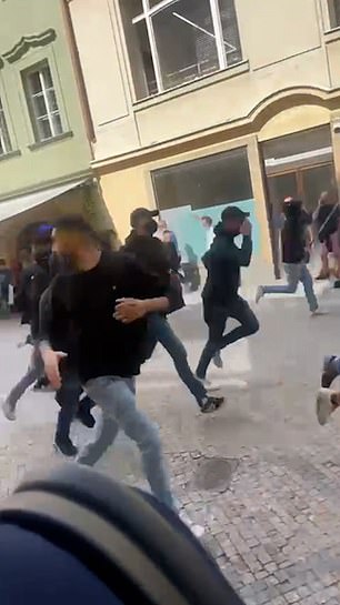 Pictured: A video clip shows the Ultras running down a Prague street. Some could be seen carrying weapons in the video