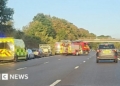 M53 bus crash: School coach full of children overturns on motorway