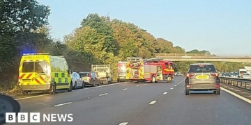 M53 bus crash: School coach full of children overturns on motorway
