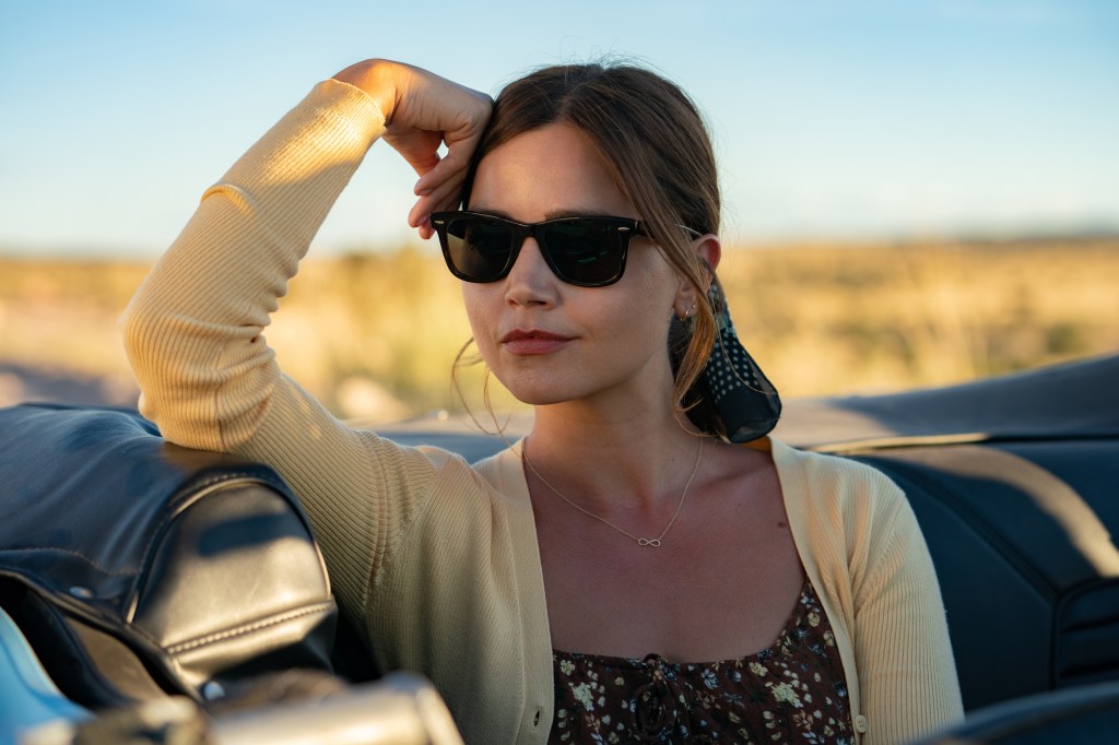 Liv (Jenna Coleman) wearing sunglasses smirking. 