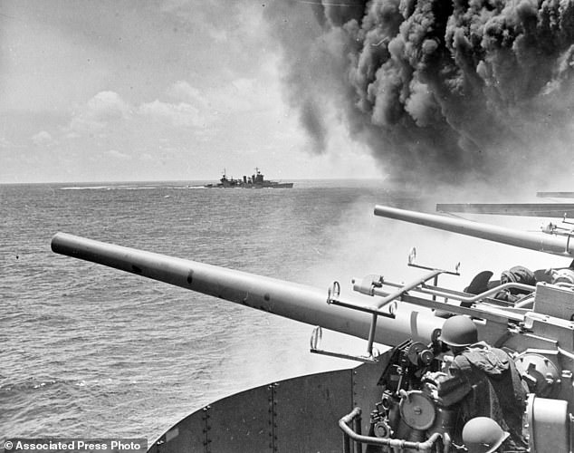 In this June 4, 1942 file photo provided by the U.S. Navy the USS Astoria  steams by USS Yorktown  shortly after the carrier had been hit by three Japanese bombs in the battle of Midway
