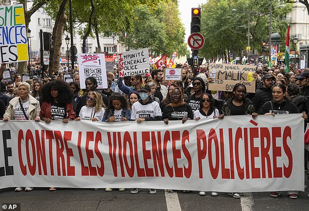 People march with a banner that reads 'against police violence' in Paris, Saturday, Sept. 23