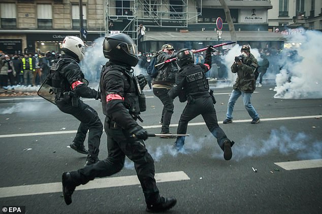 Riot police clash with protesters after a demonstration against a controversial global security law, in Paris, France, 28 November 2020