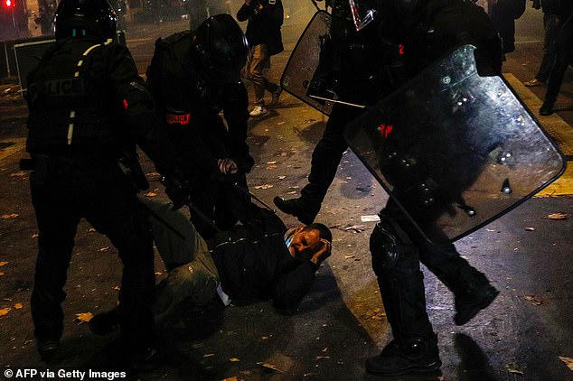 A demonstrator is arrested by a group of French anti-riot police during a demostration in Paris in November 2020. Protestors were rallying against a law that would restrict sharing images of police, only days after the country was shaken by footage showing officers beating and racially abusing a black man
