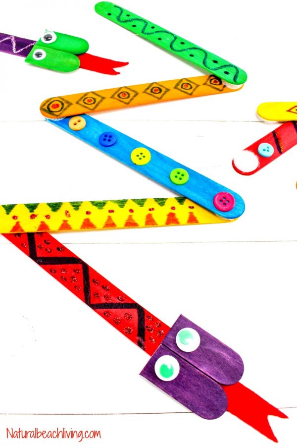 Easy crafts for kids use popsicle sticks like this one that uses colored popsicle sticks to form the bodies of snakes. Buttons and drawings are on each stick.