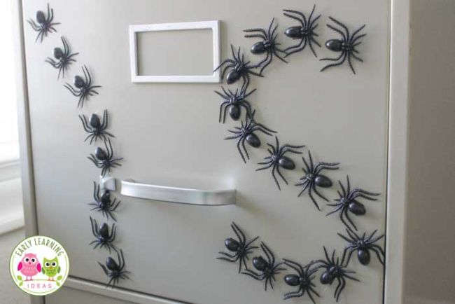 Halloween Activities can include spiders like this one. Plastic spider magnets on a filing cabinet spelling out I and S