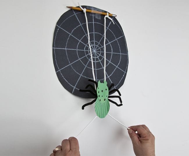 Spider STEM project that uses string to have a construction paper spider climb up a wall