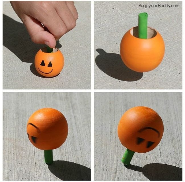 Inverted spinning wooden tops painted to look like a pumpkin (Halloween Activities)