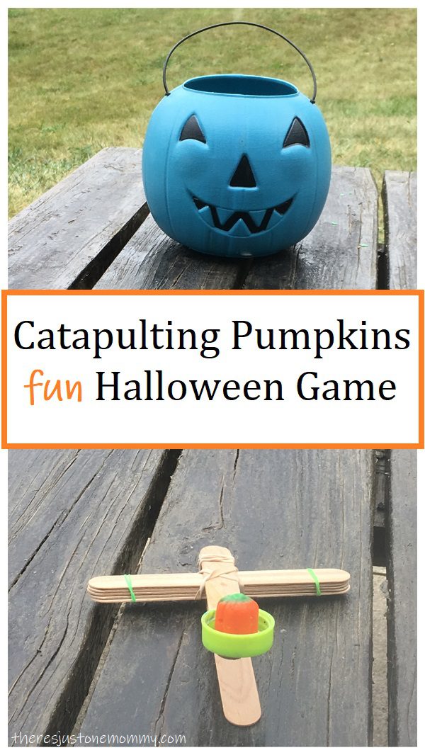 A catapult is made from popsicle sticks and rubber bands; a candy corn pumpkin is sitting on it (Halloween Activities)