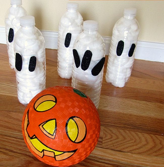 Plastic bottles filled with cotton swabs and painted to look like ghosts with an orange jack-o-lantern rubber ball (Halloween Activities)