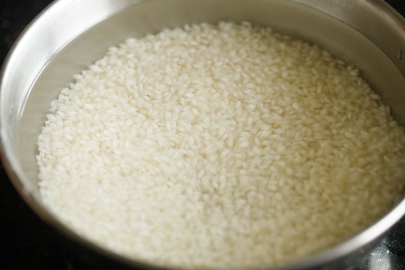 rice soaked in a bowl for making paddu. 
