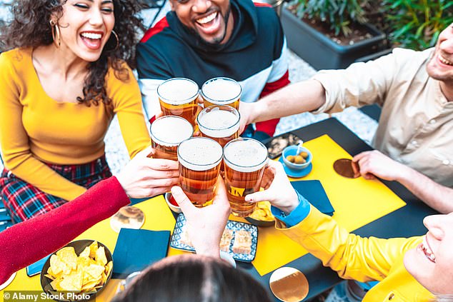 Guidance encourages barmen to avoid any language that makes people feel pressured to drink. Pictured: A group of people raise their pints of beer in a toast
