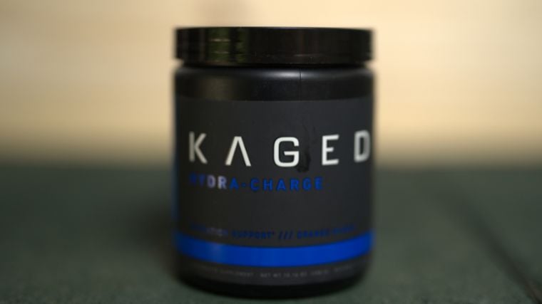 A container of Kaged Hydra Charge with a wood background