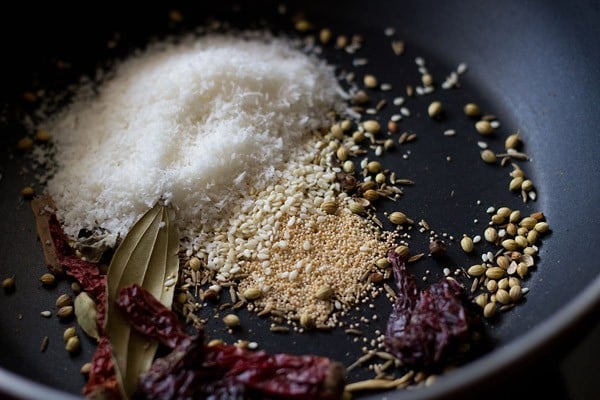 adding poppy seeds, sesame seeds and desiccated coconut to roasting spices