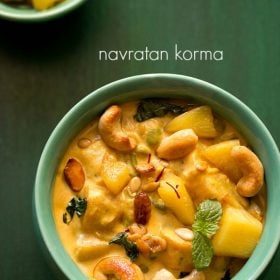 navratan korma garnished with a mint sprig and served in a green bowl with text layover.