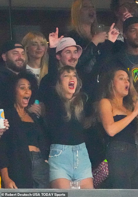 Score! Taylor threw her arms up into the air as she cheered on Kelce during the game on Sunday with her A-list pals
