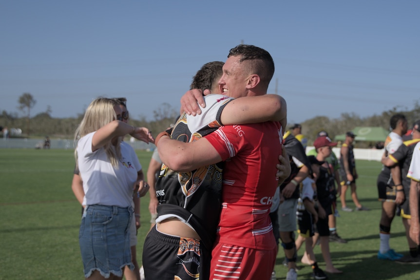 rugby league player jack wighton hugs another player after a game