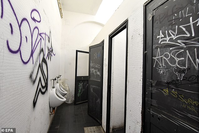 A group of young men and boys forced the girl and her boyfriend into a public bathroom (pictured)