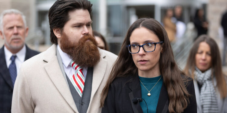 A photo of Jennifer Adkins standing outside of a courthouse.