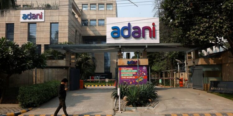 © Reuters. A man walks past a corporate office of Adani Group in Gurugram, India, November 22, 2024. REUTERS/Priyanshu Singh/File Photo