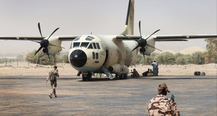 French and Chadian soldiers are seen at Faya-Largeau airport in northern Chad, preparing to board a Chadian national army CJ27 Spartan transport plane