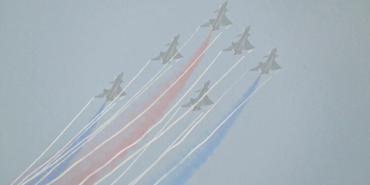 China's big air show opened with a glitzy aerial display of its fighters, but crowds couldn't see much in the smog