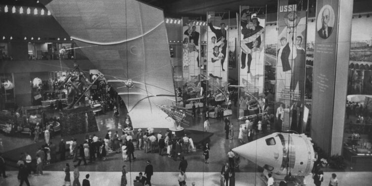 several cone-shaped spacecraft on display on a museum floor