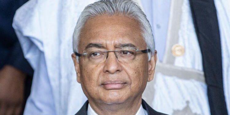 A close-up shot of Pravind Jugnauth. He has grey hair and is wearing glasses.